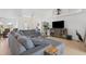 Bright living room with tile floors, a spacious sectional sofa, and a large entertainment center at 423 Boundary Blvd, Rotonda West, FL 33947