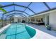Enclosed pool area features ample seating and a pristine pool, perfect for entertaining or relaxing at 423 Boundary Blvd, Rotonda West, FL 33947