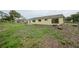 Expansive backyard with a neighboring house in the distance, offering space and potential at 4371 Tollefson Ave, North Port, FL 34287