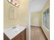 Bathroom featuring vanity with wood cabinet, mirror, and view to room beyond at 4371 Tollefson Ave, North Port, FL 34287