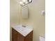 Cozy bathroom features a single sink vanity, illuminated mirror, and neutral wall color at 4371 Tollefson Ave, North Port, FL 34287