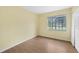 Bedroom with hardwood-look floor, closet, and a window view at 4371 Tollefson Ave, North Port, FL 34287