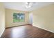 Bedroom featuring ceiling fan, light wood floor, and window with green view at 4371 Tollefson Ave, North Port, FL 34287