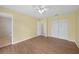 Bedroom with ceiling fan, wood-look floors, closet, and door to hall at 4371 Tollefson Ave, North Port, FL 34287