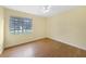 Bedroom with hardwood-look floor and window offering a neighborhood view at 4371 Tollefson Ave, North Port, FL 34287