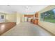 Open kitchen with tiled floor, wood cabinets, white appliances, and views to other rooms at 4371 Tollefson Ave, North Port, FL 34287