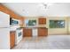 Functional kitchen with modern white appliances, wood cabinets, and tiled flooring at 4371 Tollefson Ave, North Port, FL 34287