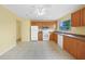 Well-lit kitchen features tiled flooring, wooden cabinets, and modern appliances at 4371 Tollefson Ave, North Port, FL 34287