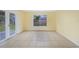Bright living room featuring tile floors, a window view, and glass patio doors at 4371 Tollefson Ave, North Port, FL 34287