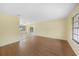 Spacious living room with hardwood floors and a smooth transition to the tiled kitchen space at 4371 Tollefson Ave, North Port, FL 34287