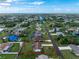 An aerial view of a beautiful single-story home with a large backyard in a serene neighborhood at 4399 Mundella Cir, Port Charlotte, FL 33948