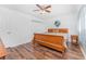 The bedroom offers wood floors, a ceiling fan, and double door closet space at 4399 Mundella Cir, Port Charlotte, FL 33948