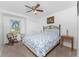 Carpeted bedroom with ceiling fan and picture window offers natural light at 4399 Mundella Cir, Port Charlotte, FL 33948