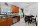 Bright kitchen featuring wood cabinets, granite countertops, stainless steel appliances, and a breakfast nook at 4399 Mundella Cir, Port Charlotte, FL 33948