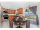 Eat-in kitchen featuring wooden cabinets, stainless steel appliances, and a view of the lanai at 4399 Mundella Cir, Port Charlotte, FL 33948