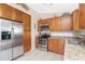 The efficiently designed kitchen features stainless appliances, wood cabinets, and tile flooring at 4399 Mundella Cir, Port Charlotte, FL 33948