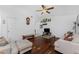 Spacious living room featuring wood floors, vaulted ceiling, ceiling fan, and ample natural light at 4399 Mundella Cir, Port Charlotte, FL 33948