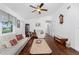 Bright living room featuring hardwood floors, a ceiling fan, comfortable seating, and neutral paint at 4399 Mundella Cir, Port Charlotte, FL 33948