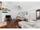 Bright living room with hardwood floors, a ceiling fan, comfortable seating, and natural lighting at 4399 Mundella Cir, Port Charlotte, FL 33948