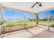 Enclosed patio with tile flooring, ceiling fan and a view of the landscaped backyard at 4399 Mundella Cir, Port Charlotte, FL 33948