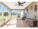 Enclosed patio featuring tile flooring, ceiling fan and access to the backyard at 4399 Mundella Cir, Port Charlotte, FL 33948