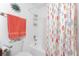 Bright bathroom featuring a shower with a fun, colorful seahorse-themed shower curtain at 4399 Mundella Cir, Port Charlotte, FL 33948