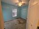 Cozy bedroom with blue painted walls, a window for natural light, and a ceiling fan at 4900 Hurley Ave, North Port, FL 34288