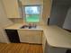 Bright kitchen featuring a dishwasher, sink, and a large window with a view of the outdoors at 4900 Hurley Ave, North Port, FL 34288