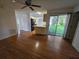 Bright living room with hardwood floors, leading to the kitchen and an outdoor patio at 4900 Hurley Ave, North Port, FL 34288