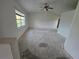 Spacious living room featuring a large window providing natural light and ceiling fan at 4900 Hurley Ave, North Port, FL 34288