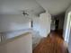 Open-concept living room featuring a ceiling fan and transitions to the kitchen with hardwood flooring at 4900 Hurley Ave, North Port, FL 34288