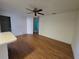 Open living room featuring hardwood floors, ceiling fan, and a view of an adjacent room at 4900 Hurley Ave, North Port, FL 34288
