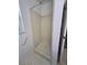 Bathroom shower stall with white paneling and neutral tile flooring at 4900 Hurley Ave, North Port, FL 34288
