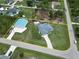 Aerial view of property featuring home, garage, pool and lot boundary outlined in yellow at 5412 Ulysses St, Port Charlotte, FL 33981