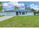 Classic single-story home boasts a garage, front lawn, and a welcoming front door at 5412 Ulysses St, Port Charlotte, FL 33981