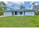 Charming single-story home with a well-kept lawn and attached garage at 5412 Ulysses St, Port Charlotte, FL 33981