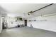 Spacious garage with white walls, utility sink, and a roll-up door with an automatic opener at 5412 Ulysses St, Port Charlotte, FL 33981