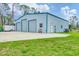 Garage with three bays offers ample storage and workspace, complimented by lush lawn at 5412 Ulysses St, Port Charlotte, FL 33981