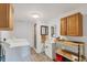 Well-lit laundry room with new washer, dryer, utility sink, and storage cabinets at 5412 Ulysses St, Port Charlotte, FL 33981
