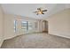 A bright living room featuring neutral walls, carpet flooring, and an arched doorway at 5412 Ulysses St, Port Charlotte, FL 33981