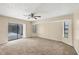 Living room featuring carpet floors, neutral walls, and access to the screened lanai at 5412 Ulysses St, Port Charlotte, FL 33981