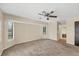 Living room with neutral walls, carpet floors, and access to a hallway and front windows at 5412 Ulysses St, Port Charlotte, FL 33981