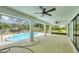 Outdoor living featuring screened-in pool, covered patio, and ceiling fans for relaxing comfort at 5412 Ulysses St, Port Charlotte, FL 33981