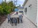 Cozy backyard retreat with a dining table and sitting area, perfect for relaxing or entertaining guests at 608 Saint Judes Dr, Longboat Key, FL 34228