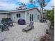 Charming backyard featuring a lounge chair, grill, dining set, and comfortable outdoor seating at 608 Saint Judes Dr, Longboat Key, FL 34228