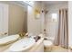 Cozy bathroom featuring a shower-tub combo, stylish sink, and ample natural light at 608 Saint Judes Dr, Longboat Key, FL 34228