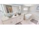 Bright and modern bathroom with dual sinks, luxurious soaking tub and modern fixtures at 608 Saint Judes Dr, Longboat Key, FL 34228