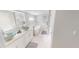 Elegant bathroom featuring dual glass bowl sinks, a soaking tub, and a spacious layout at 608 Saint Judes Dr, Longboat Key, FL 34228