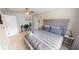 Stylish bedroom with a comfortable striped bed, ceiling fan, and modern décor at 608 Saint Judes Dr, Longboat Key, FL 34228