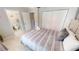 Cozy bedroom features a neutral palette, tiled floors, and ensuite bathroom with step-in shower at 608 Saint Judes Dr, Longboat Key, FL 34228